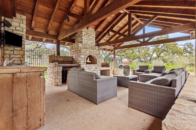 View of patio featuring a gazebo and an outdoor living space with a fireplace | Image 30