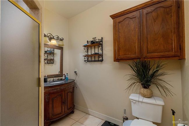 Bathroom with toilet, vanity, and tile patterned floors | Image 21