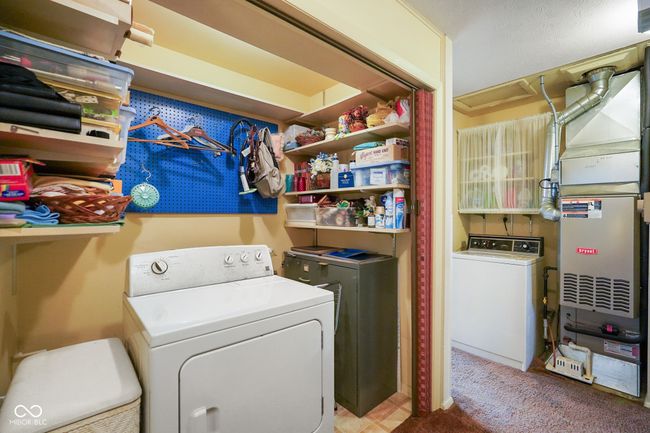 washroom featuring washer and clothes dryer and carpet flooring | Image 28