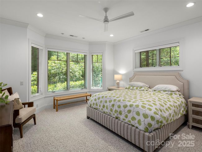 Terrace level primary suite features ample windows for private wooded views, large walk-in coset storage with custom built-ins, large enough to accommodate a baby crib. | Image 31