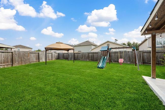 Wide backyard with room for gardening, pets, or play. | Image 25