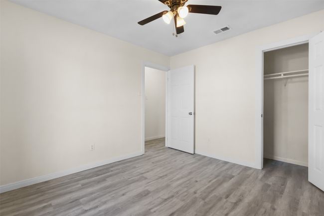 Unfurnished bedroom featuring ceiling fan, light hardwood / wood-style flooring, and a closet | Image 17