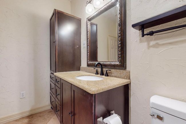 Bathroom with a textured wall, toilet, vanity, and​​‌​​​​‌​​‌‌​‌‌​​​‌‌​​‌‌​‌​​​​​‌ baseboards | Image 30