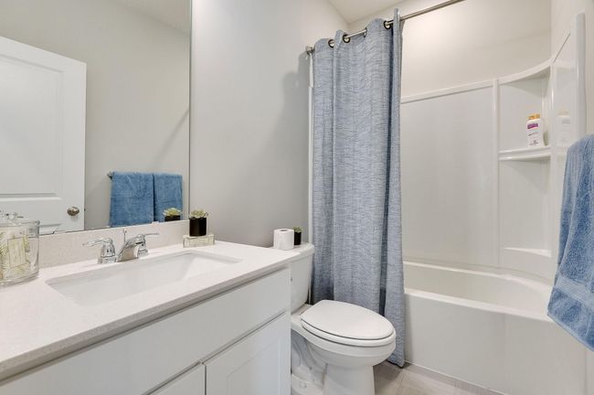 Hall bathroom for the two bedrooms at the front of the house. Photo is of a previously built model home, finishes and selections will vary. | Image 15