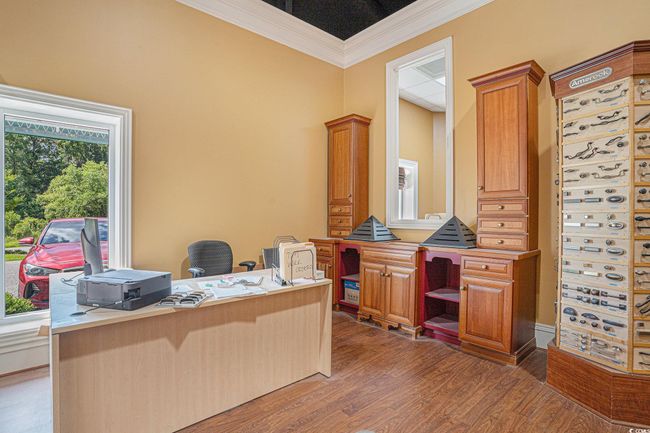Office area with crown molding and wood finished floors | Image 12