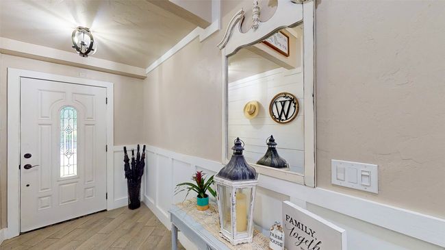 Foyer with dark hardwood / wood-style floors, plenty of natural light, and ornamental molding | Image 5