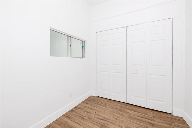 Office reception area with double closet for storage and file management. | Image 5