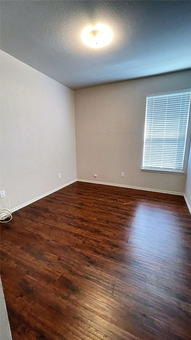 Unfurnished room featuring dark wood finished floors and a textured ceiling | Image 21