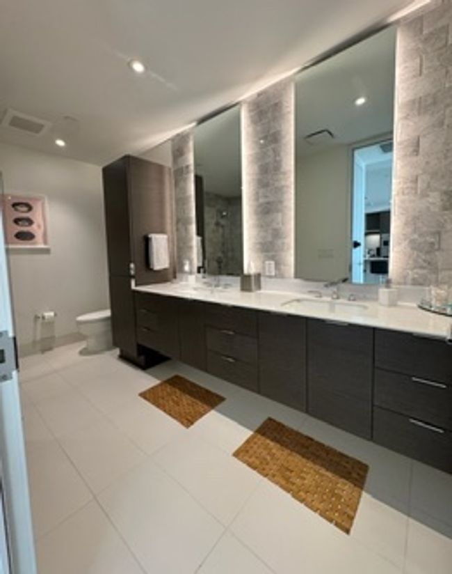 Full bathroom featuring toilet, vanity, tile patterned floors, and ornate columns | Image 11