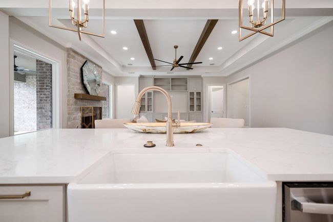 Kitchen featuring a chandelier, open floor plan, recessed lighting, a fireplace, and stainless steel dishwasher | Image 16
