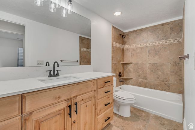 Bathroom featuring vanity and tub / shower combination | Image 34