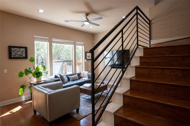 Living area with stairs, ceiling fan, dark wood-type flooring, and recessed lighting | Image 8