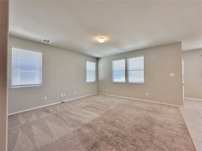 Spare room featuring baseboards and light carpet | Image 6