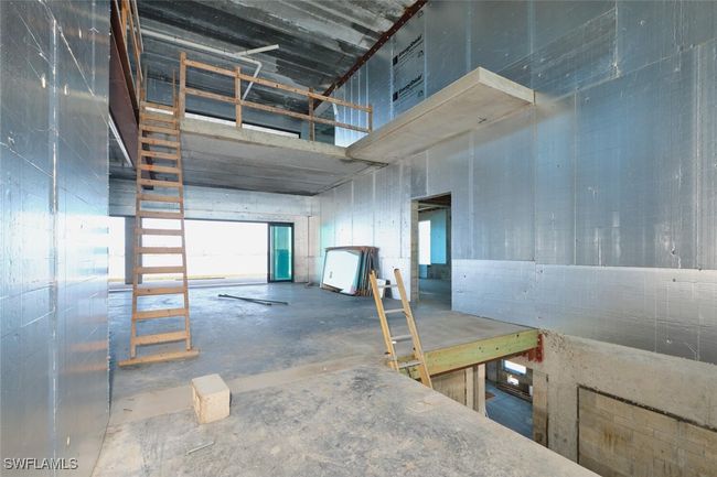 Misc room featuring concrete flooring and a towering ceiling | Image 28