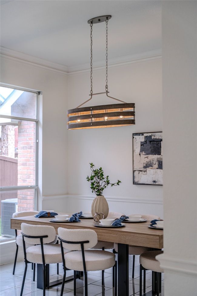Dining room featuring ornamental molding and light tile patterned floors | Image 7