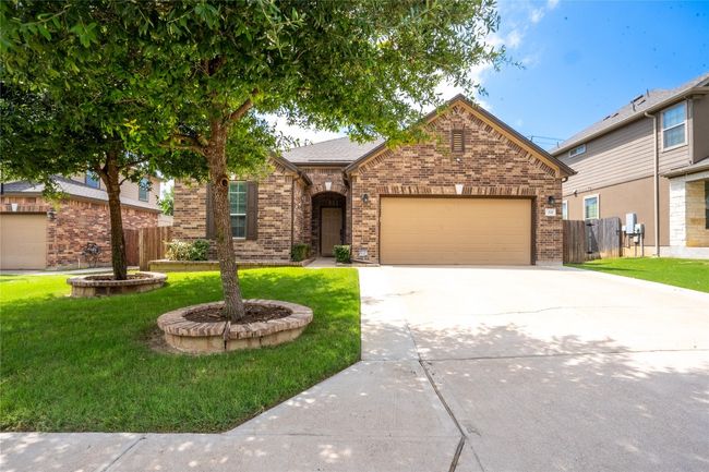 View of front facade with brick siding, driveway, and a garage | Image 30