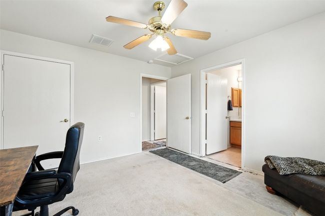Home office featuring light carpet, a ceiling fan, and attic access | Image 18