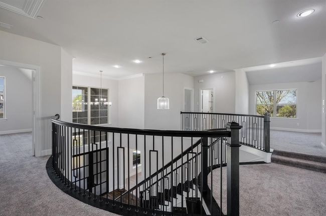 Hall featuring carpet, an upstairs landing, baseboards, recessed lighting, and a chandelier | Image 25