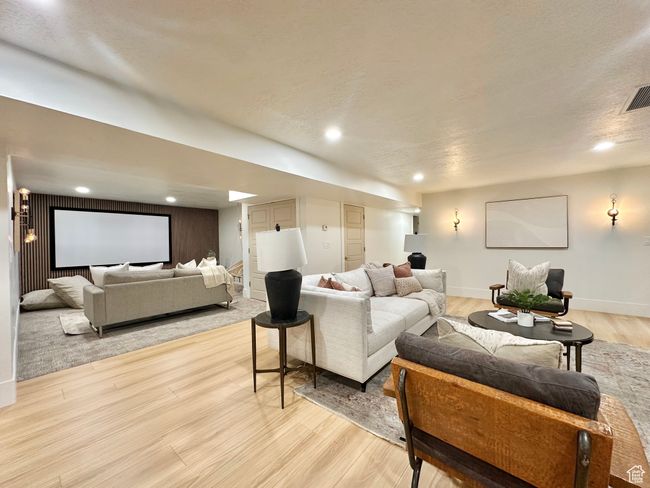 Living area with light wood-style floors and recessed lighting | Image 31