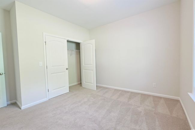 Unfurnished bedroom featuring light carpet and a closet | Image 19