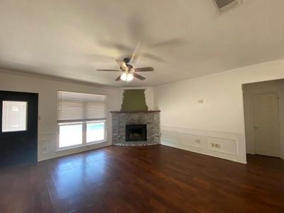 Unfurnished living room with ceiling fan, crown molding, and hardwood / wood-style flooring | Image 3