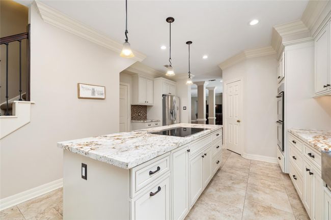 Elegant marbled granite countertops make a statement, paired with tasteful pendant lighting that adds warmth and refinement. It’s a kitchen that’s as beautiful as it is practical. | Image 19