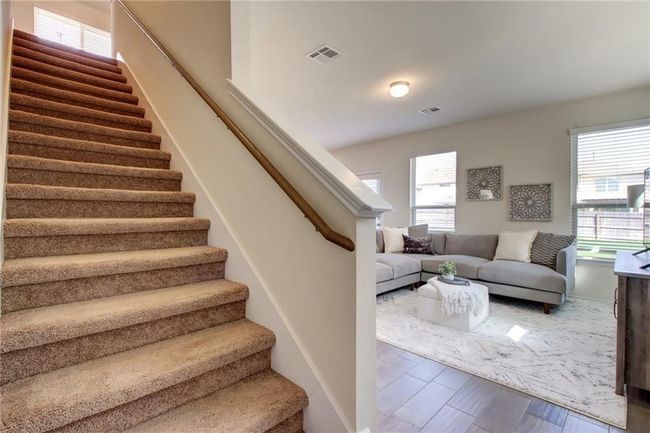 Stairs with healthy amount of natural light and wood finished floors | Image 16