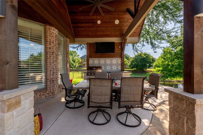 View of patio featuring outdoor dining area and area for grilling | Image 9