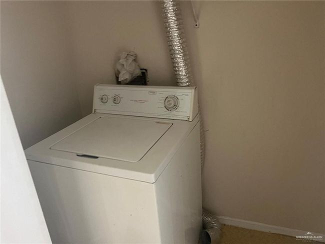 Washroom featuring washer / clothes dryer | Image 6