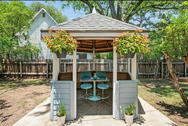 Fenced backyard with a gazebo | Image 33