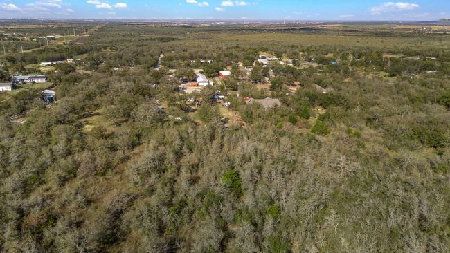 Aerial view of property and surrounding area with a heavily wooded area | Image 30