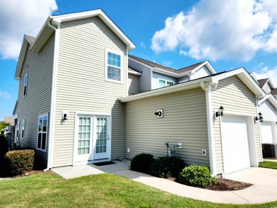 Exterior space featuring a front yard, central air condition unit, and a garage | Image 3