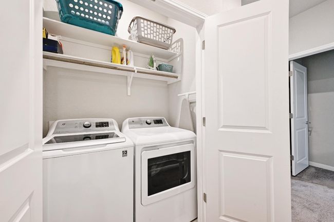 Laundry closet with built-in shelving for additional storage | Image 24