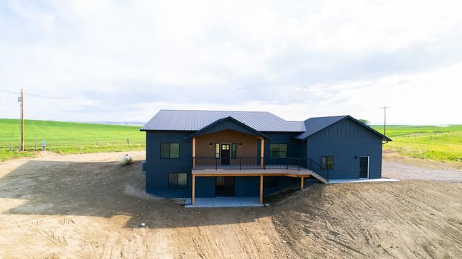 View of front of home with a rural view, board and batten siding, and a deck | Image 8