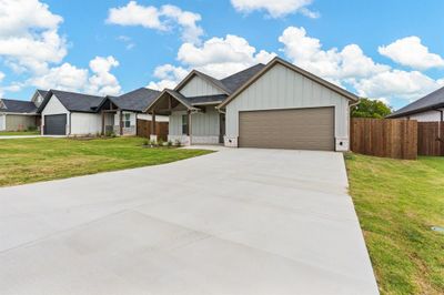 View of front of home featuring a front yard and a garage | Image 2