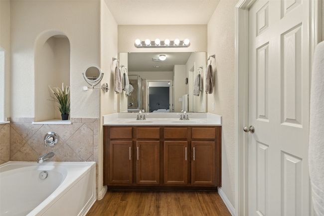 Tranquil primary suite with soundproof windows, automatic blinds, walk in closet, dual vanities, garden tub, walk in shower and private commode. | Image 22