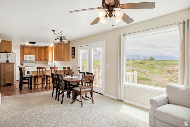 Dining room with ceiling fan, baseboards, and light carpet & amazing views | Image 4