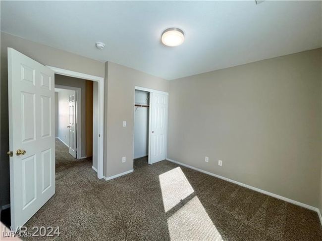 Unfurnished bedroom with a closet, carpet floors, and baseboards | Image 6