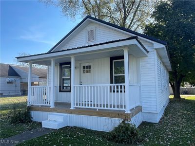 View of front of home featuring a front lawn and a porch | Image 1