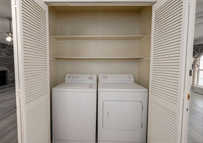 Washroom with a ceiling fan, washer and clothes dryer, and laundry area | Image 14