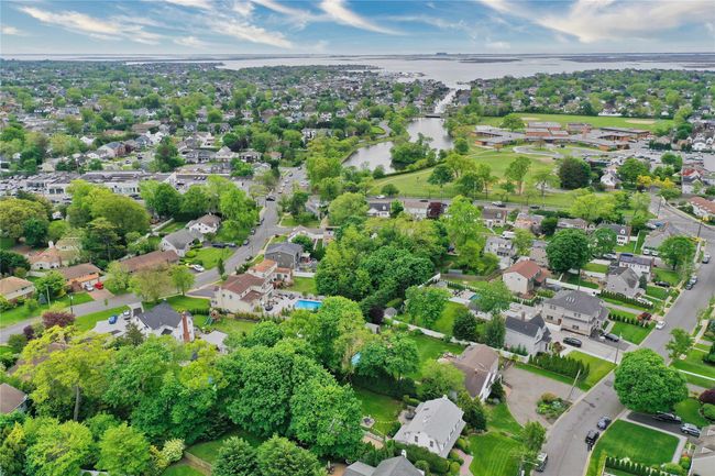Aerial view of property and surrounding area featuring a large body of water and nearby suburban area | Image 38