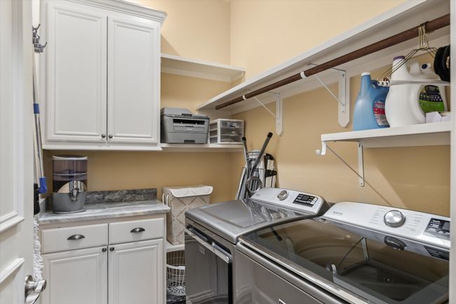 Washroom with washing machine and dryer and cabinet space | Image 20