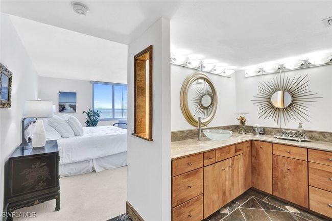 Bathroom featuring ensuite bathroom, a sink, marble finish floor, double vanity, and visible vents | Image 22