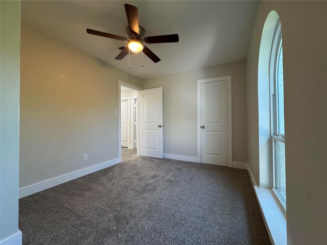 Unfurnished bedroom featuring ceiling fan, baseboards, and carpet floors | Image 11