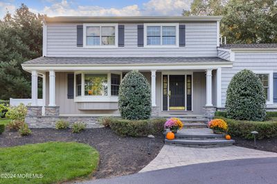 vinyl siding, paver entrance way and porch, professionally landscaped | Image 1