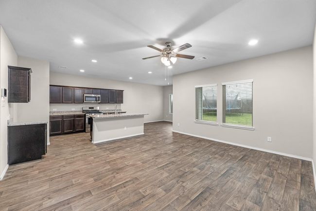 This kitchen offers a considerable and inviting island that opens into living/family room. You can easily accommodate 4 large barstools at this island with an additional opportunity to add a kitchen table in the kitchen eating area room. | Image 16
