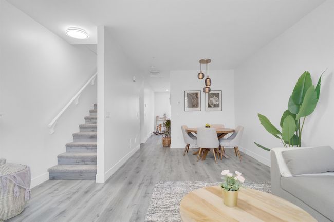 Dining area featuring stairs, baseboards, and light wood finished floors | Image 13