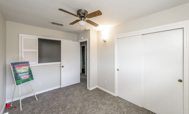 Unfurnished bedroom featuring a closet, a ceiling fan, baseboards, visible vents, and carpet | Image 21