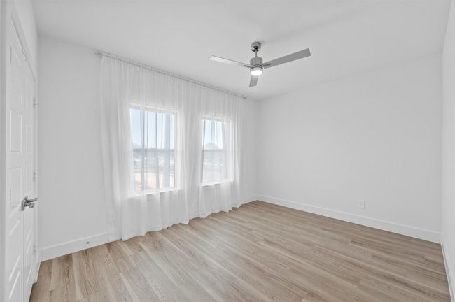 Spare room with light wood-type flooring and ceiling fan | Image 15