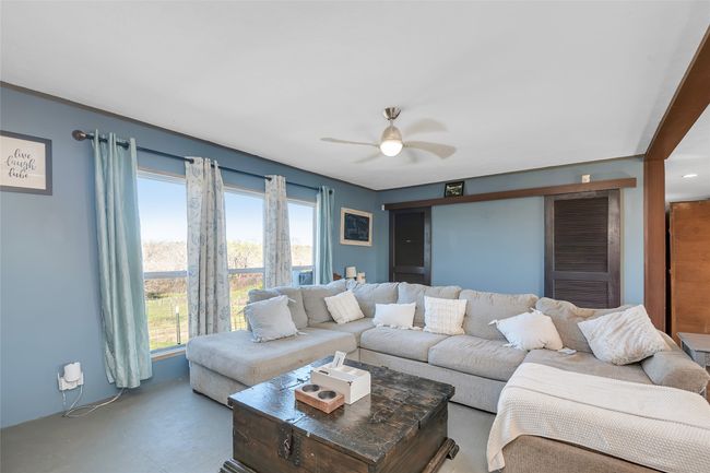 Living area with finished concrete flooring and a ceiling fan | Image 22